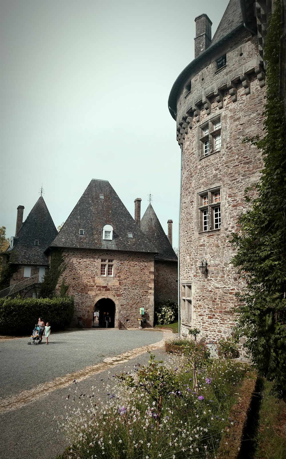 a couple of people on a motor bike in front of a castle