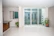 Bright living room with newly installed sliding UPVC windows revealing a sunny garden view.