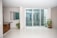 A bright living room featuring elegant bifolding doors opening to a garden.