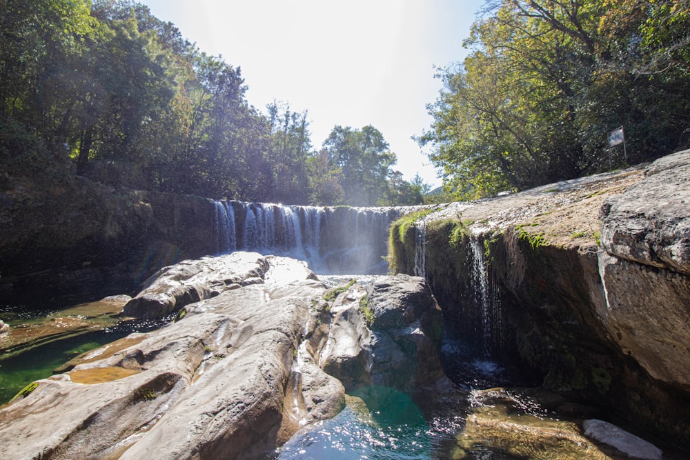 a waterfall with water cascading down it's sides