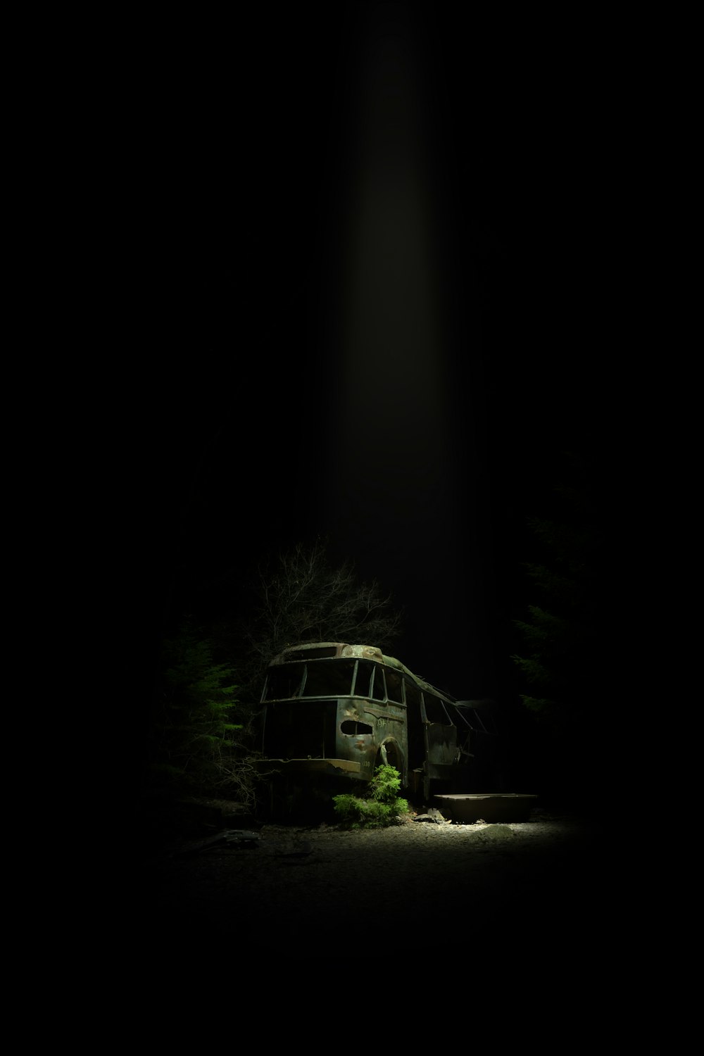 an old bus sitting in the middle of the night