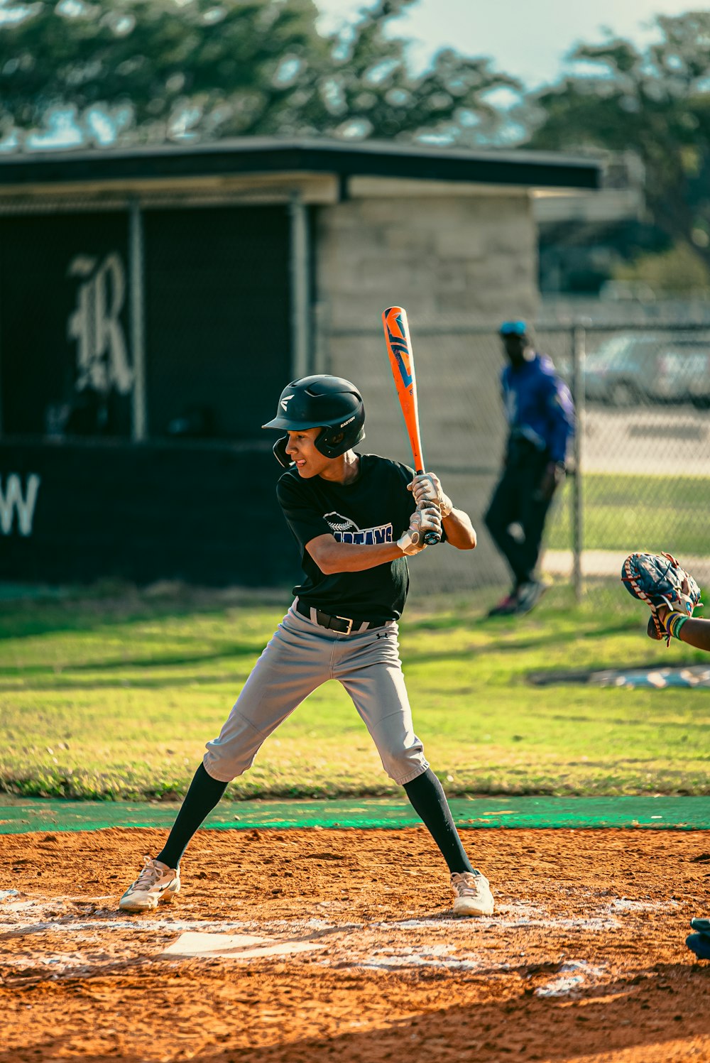 a baseball player holding a bat on top of a field