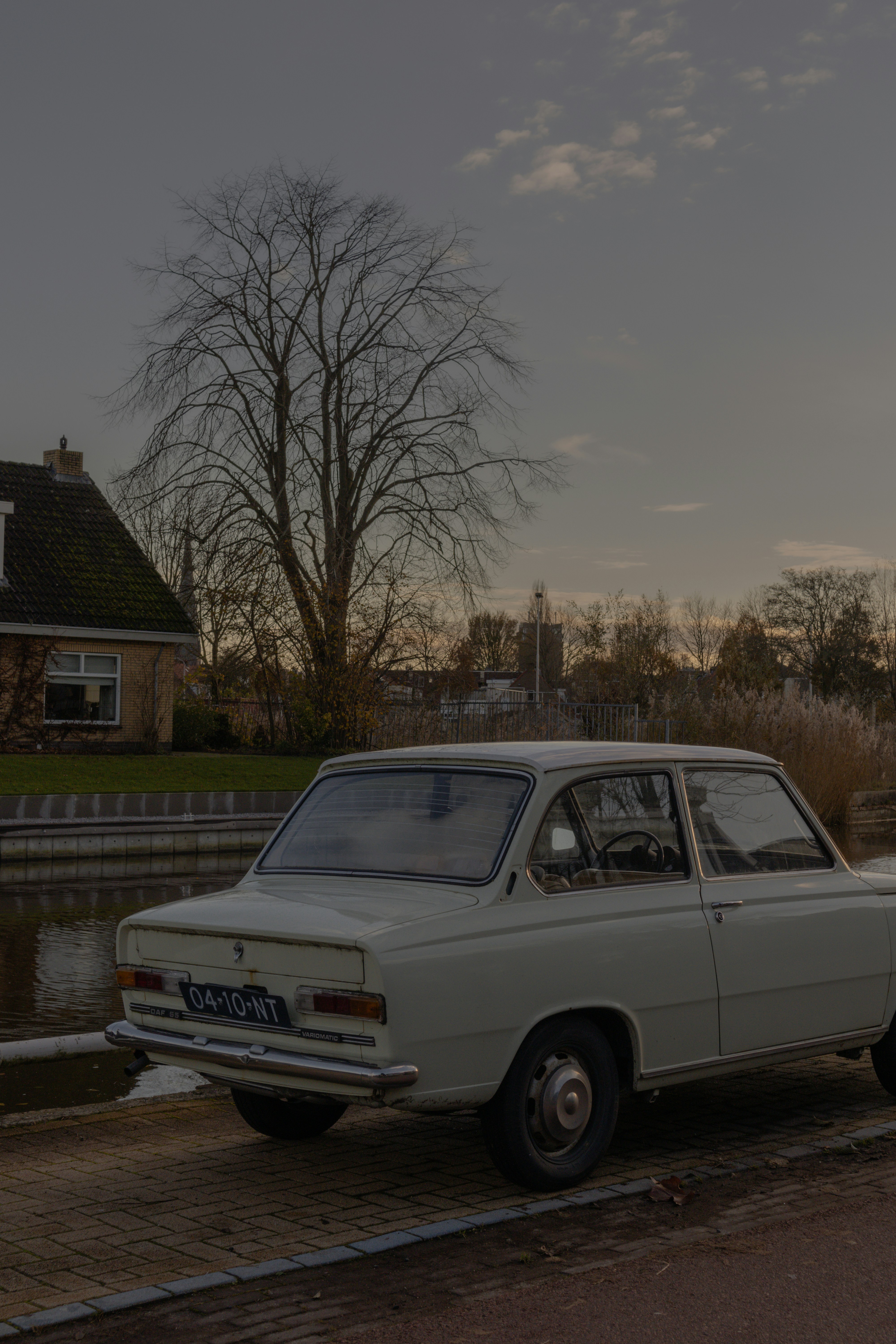 a white car parked next to a body of water