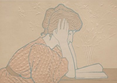 A stylized illustration of a woman with short hair and patterned clothing leaning her head on her hand. She appears to be reading a book, which is open on the table. The background is intricate, featuring embossed floral designs.