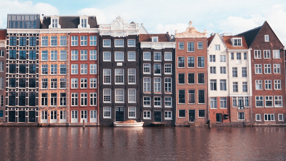 a row of buildings next to a body of water