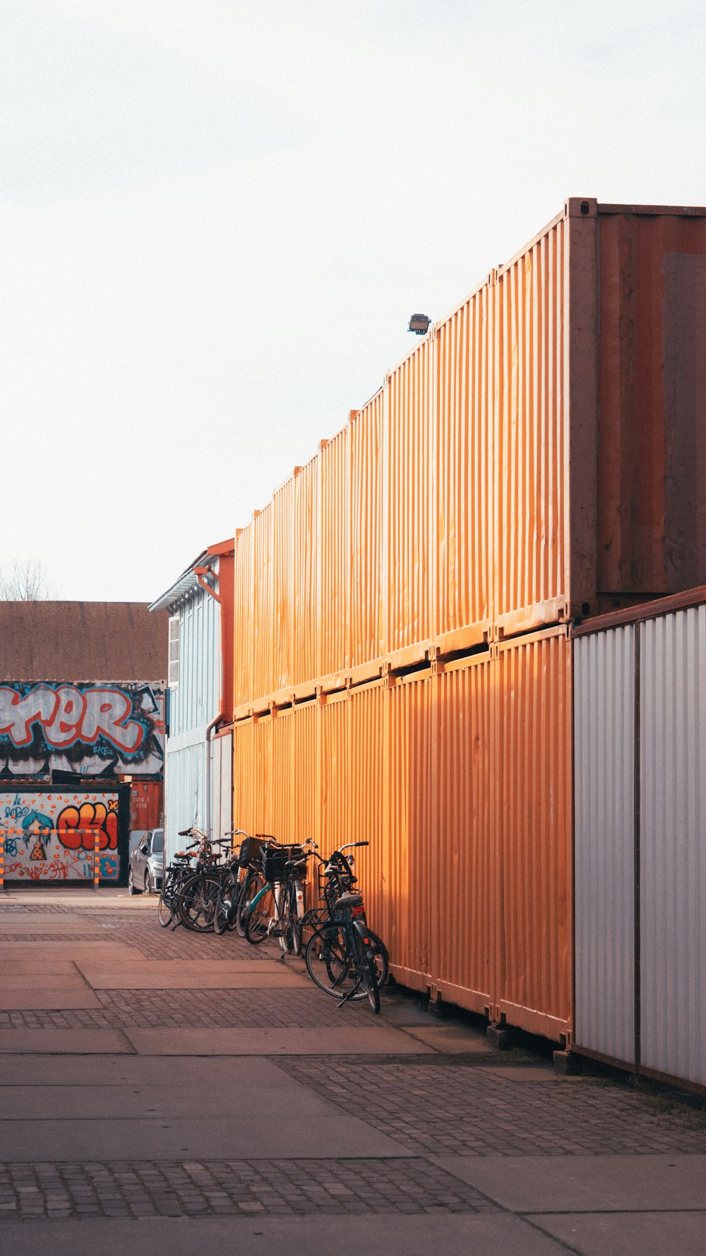 a bunch of bikes are parked next to a wall