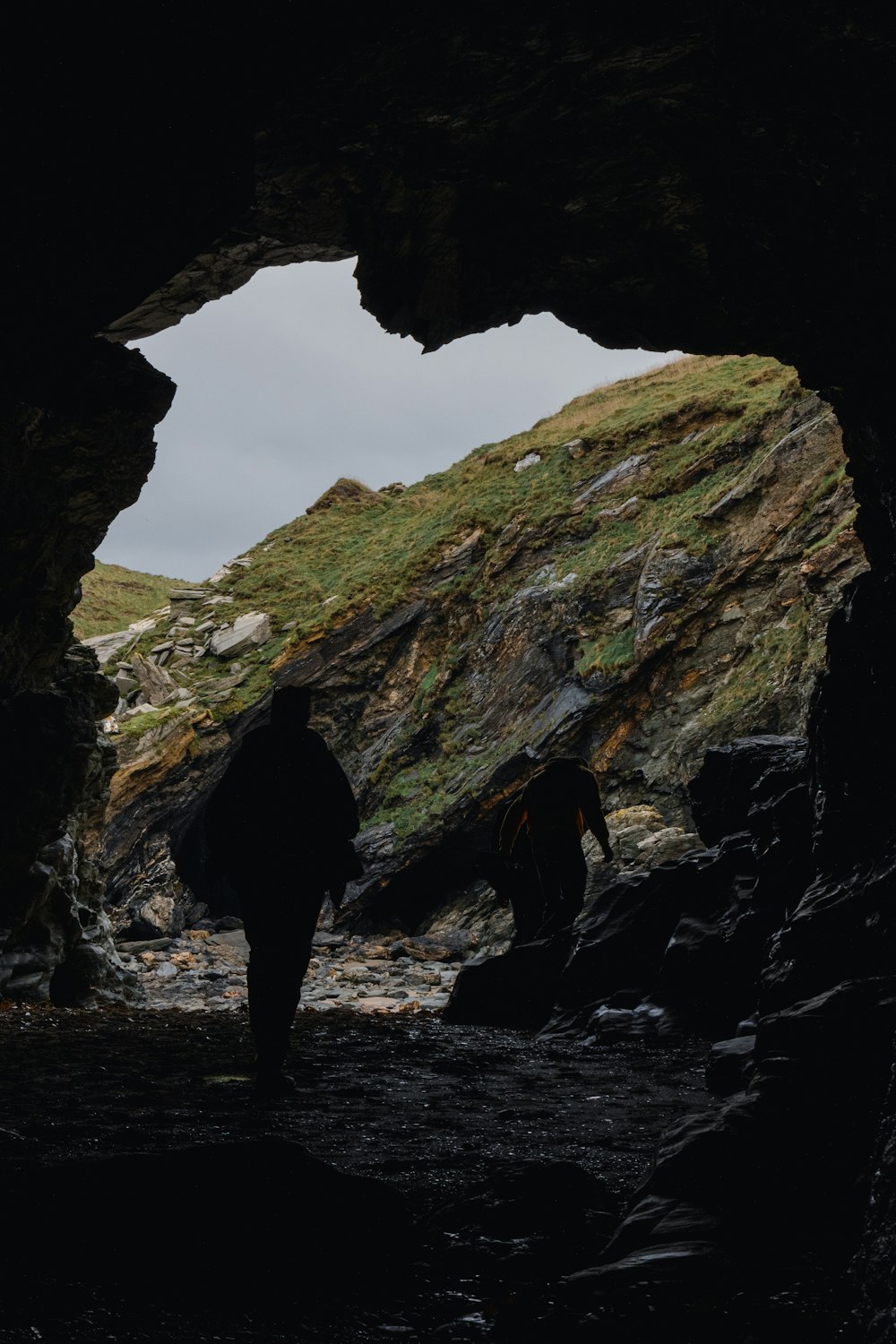 a couple of people that are standing in a cave