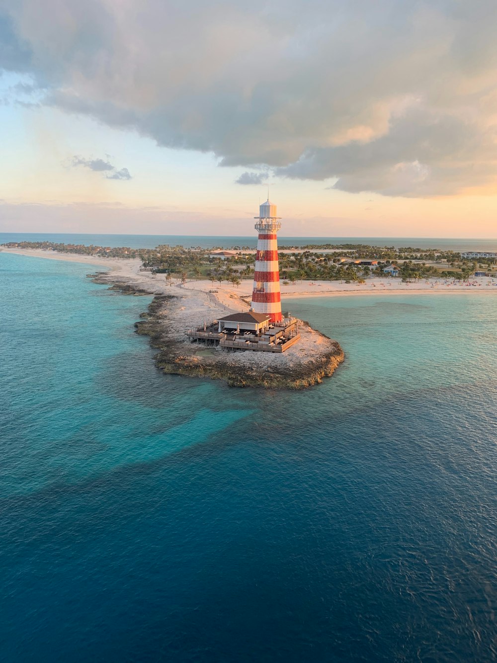 a lighthouse on an island in the middle of the ocean