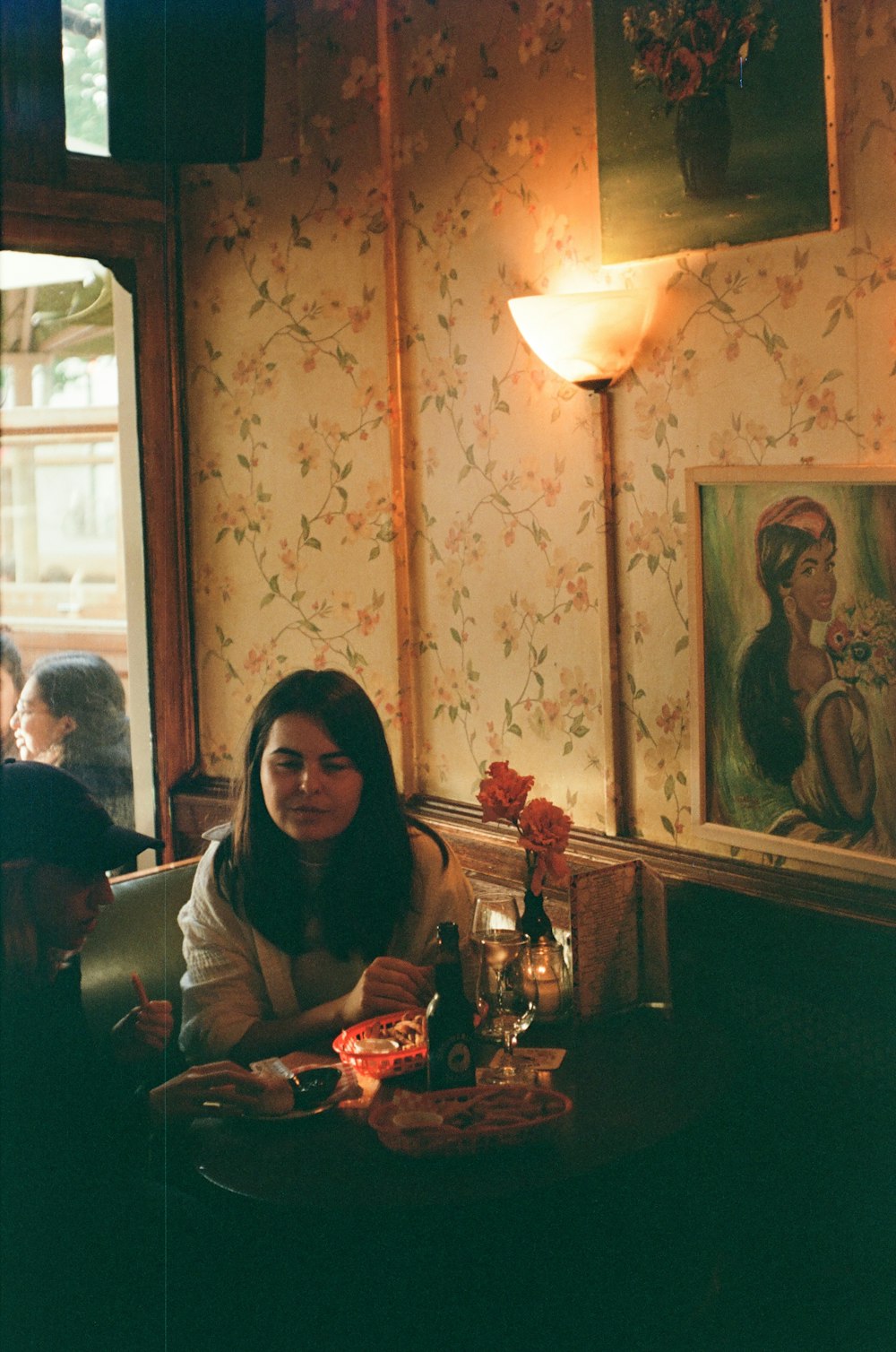 a woman sitting at a table in a restaurant