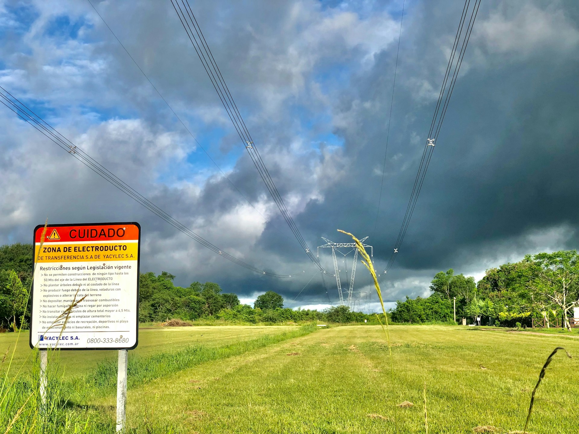 woman wearing yellow long-sleeved dress under white clouds and blue sky during daytime