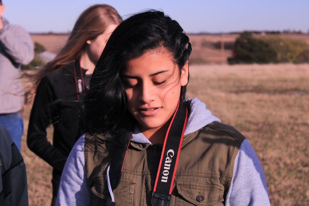 a girl with a camera around her neck