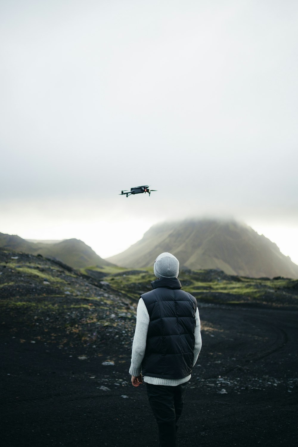 a person looking at a plane in the sky