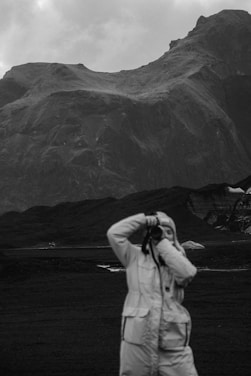 a person taking a picture of a mountain