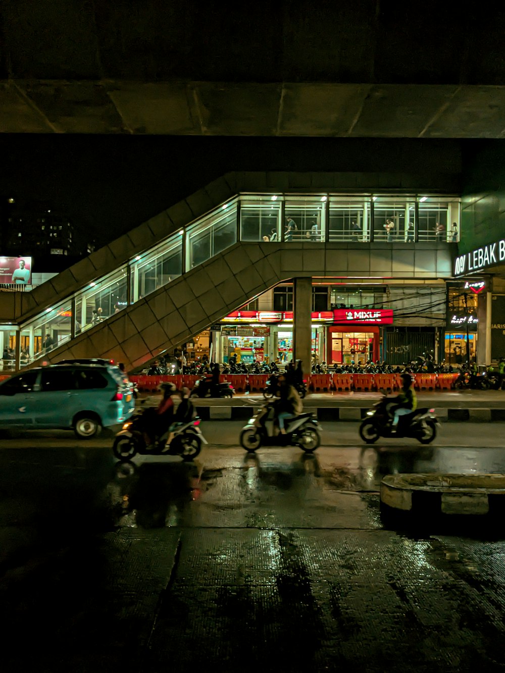 a group of people riding motorcycles down a street