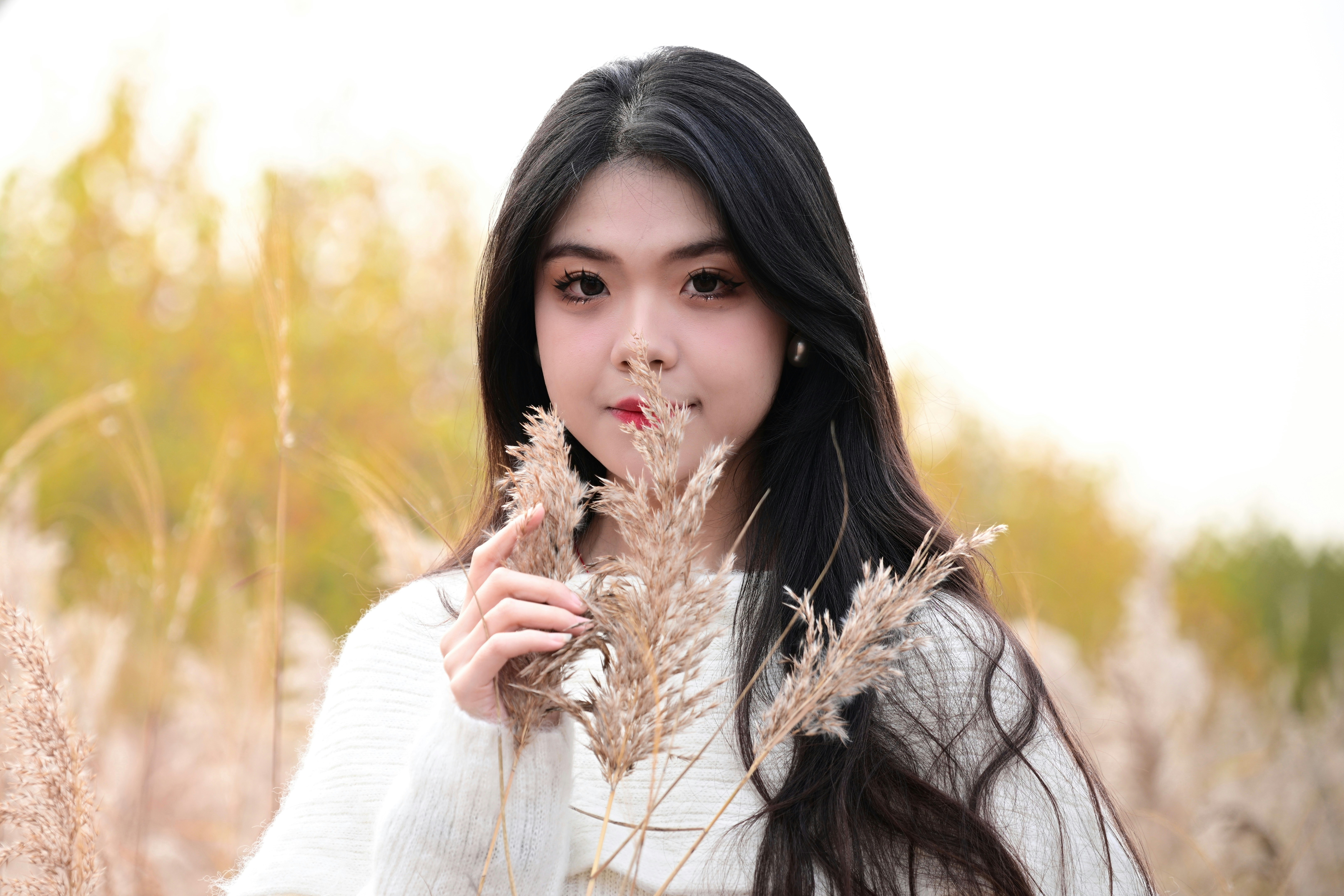 A woman standing in a field of tall grass photo – Free Woman Image on ...