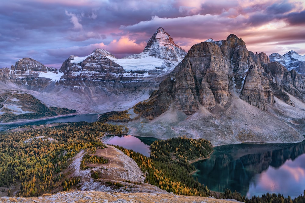 a mountain range with a lake in the foreground