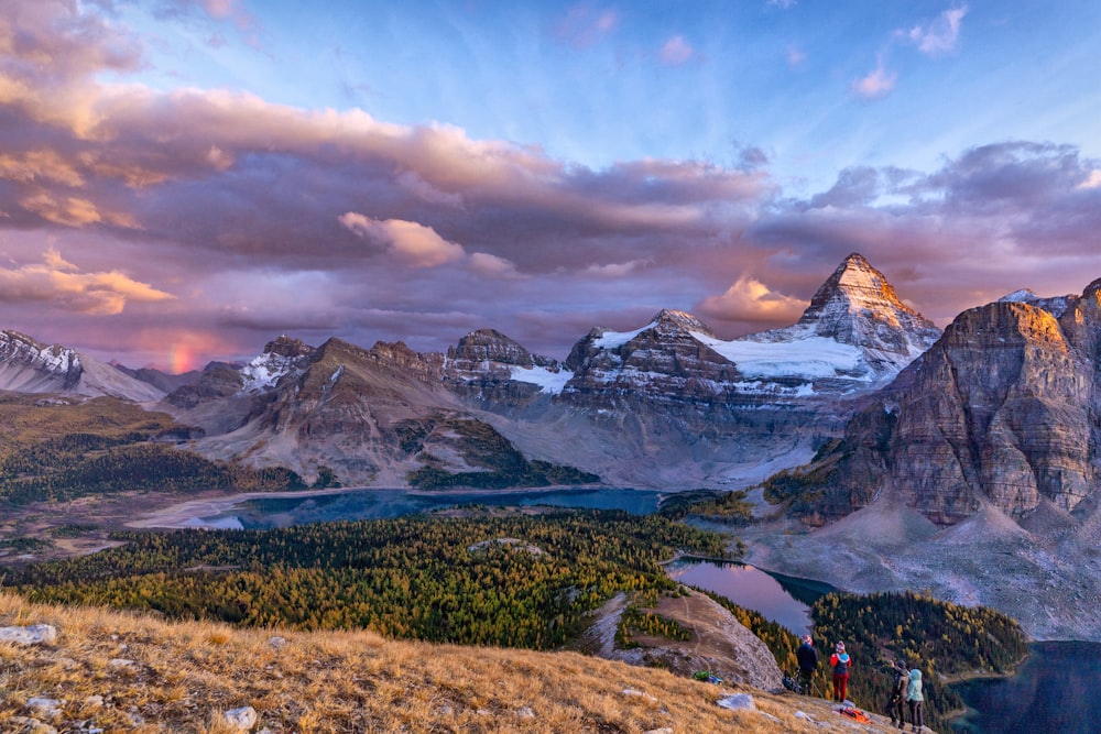 a group of people standing on top of a mountain