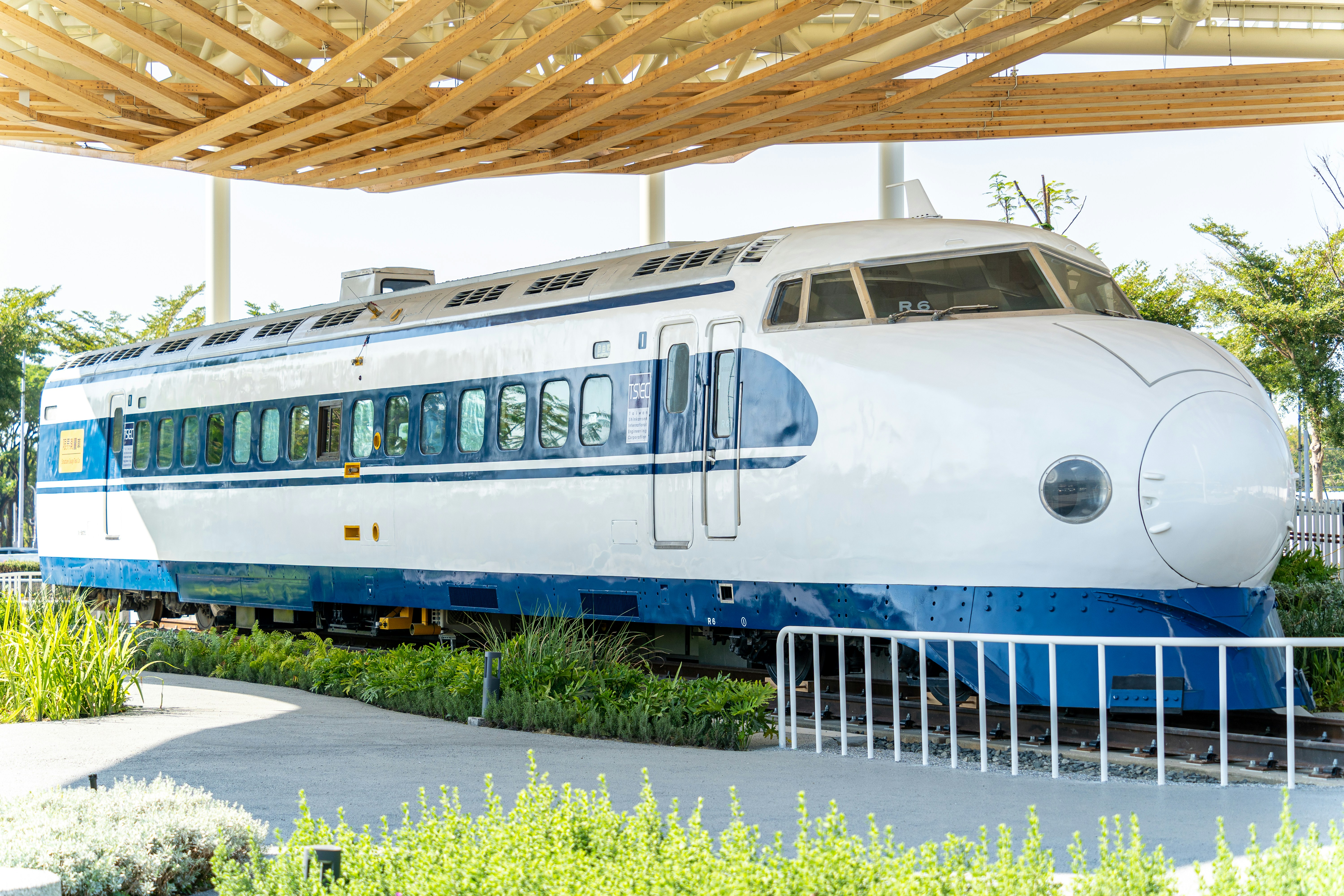 a white and blue train is on the tracks