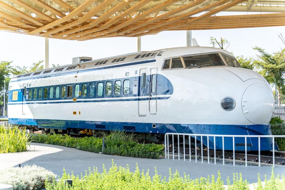 a white and blue train is on the tracks