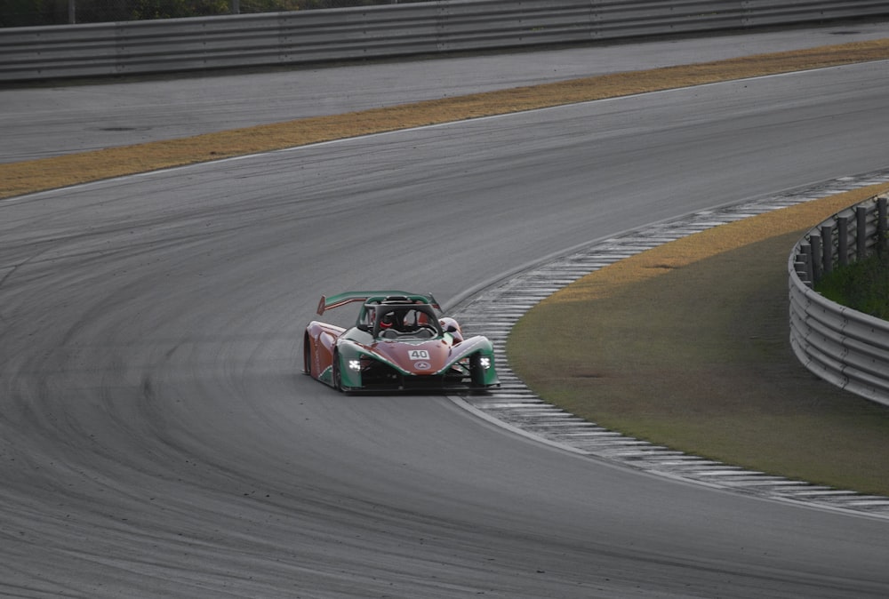 a man driving a race car on a race track