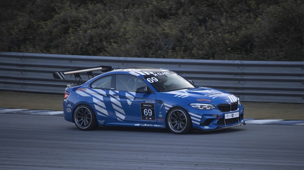 a blue car driving on a race track