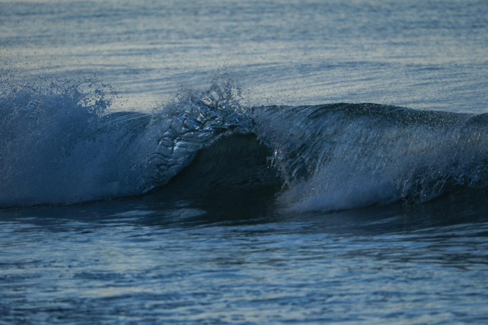 a person riding a wave on top of a surfboard