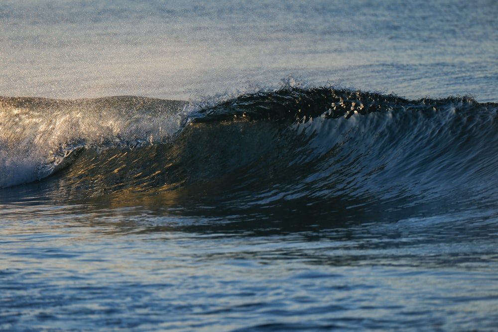 a man riding a wave on top of a surfboard