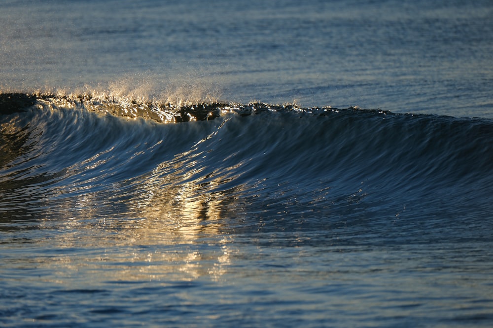 a person riding a wave on top of a surfboard