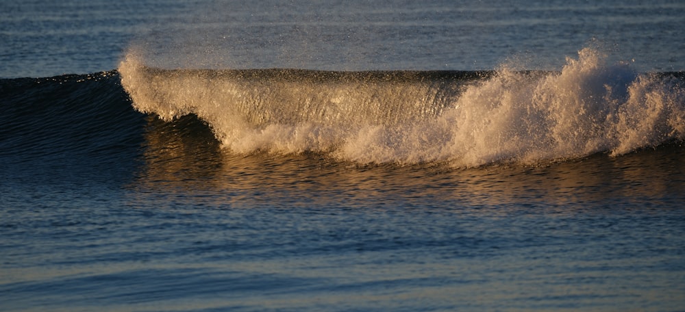 a person riding a wave on top of a surfboard