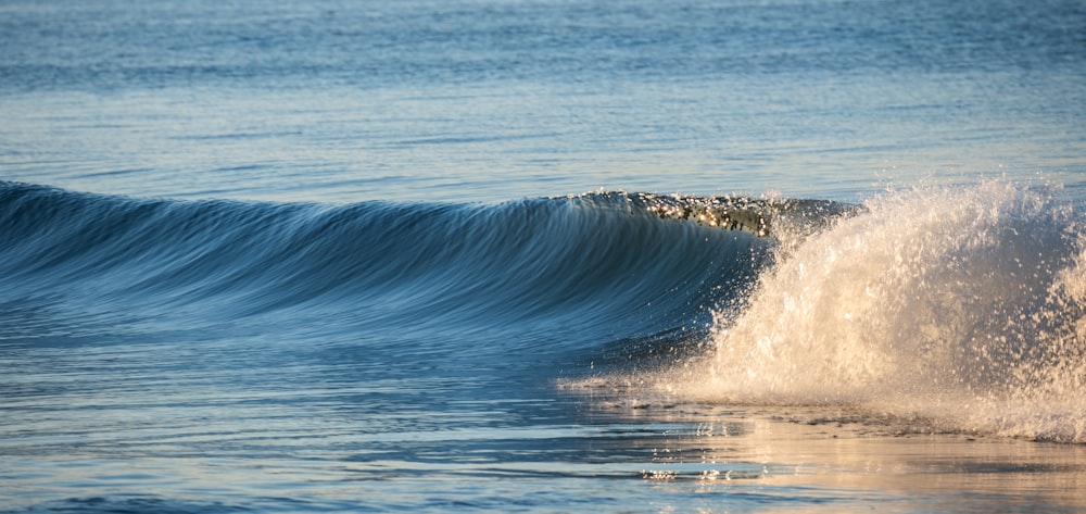 a person riding a wave on top of a surfboard