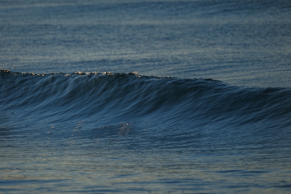 a man riding a wave on top of a surfboard