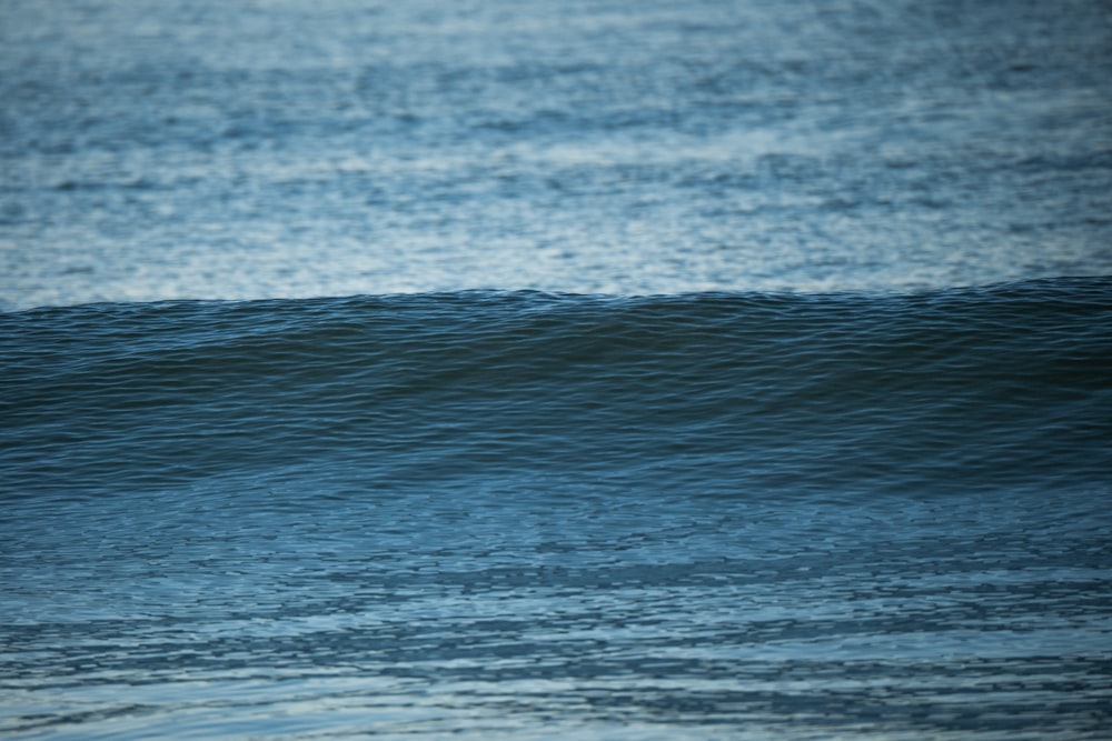 a man riding a wave on top of a surfboard