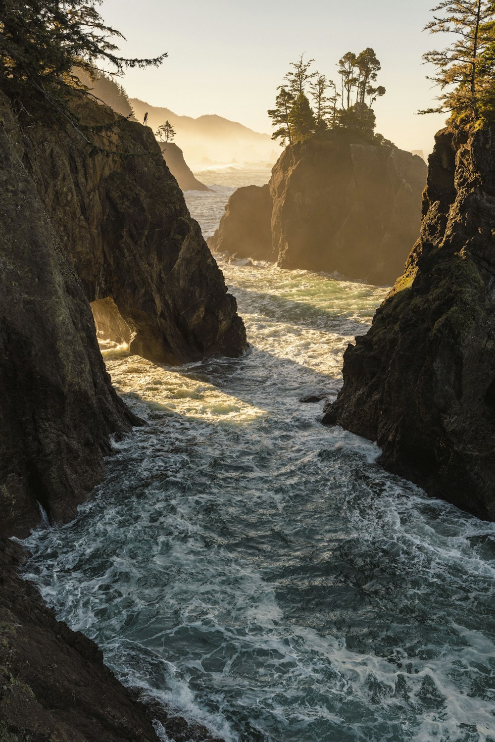 a body of water surrounded by rocks and trees