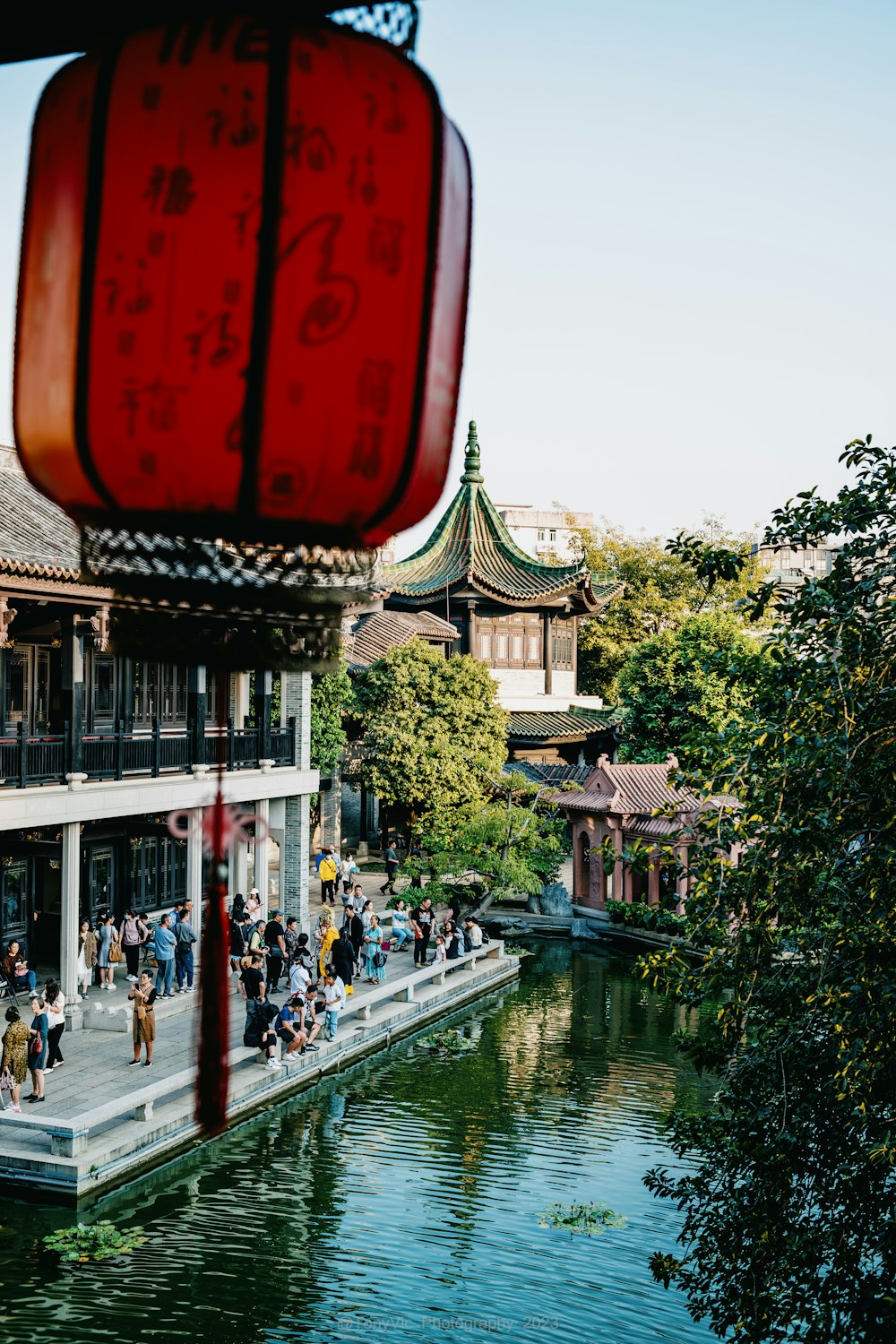 a group of people walking on a bridge over a river