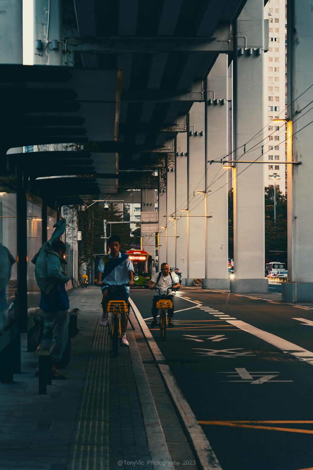 a group of people riding bikes down a street