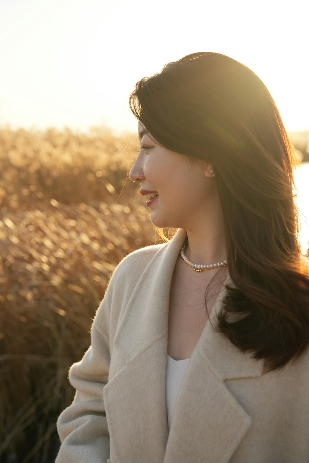 a woman standing in a field of tall grass