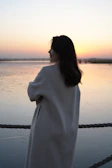 A sensual woman posing gracefully by the Le Havre waterfront at sunset.