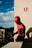 a man in a spider suit sitting on a ledge