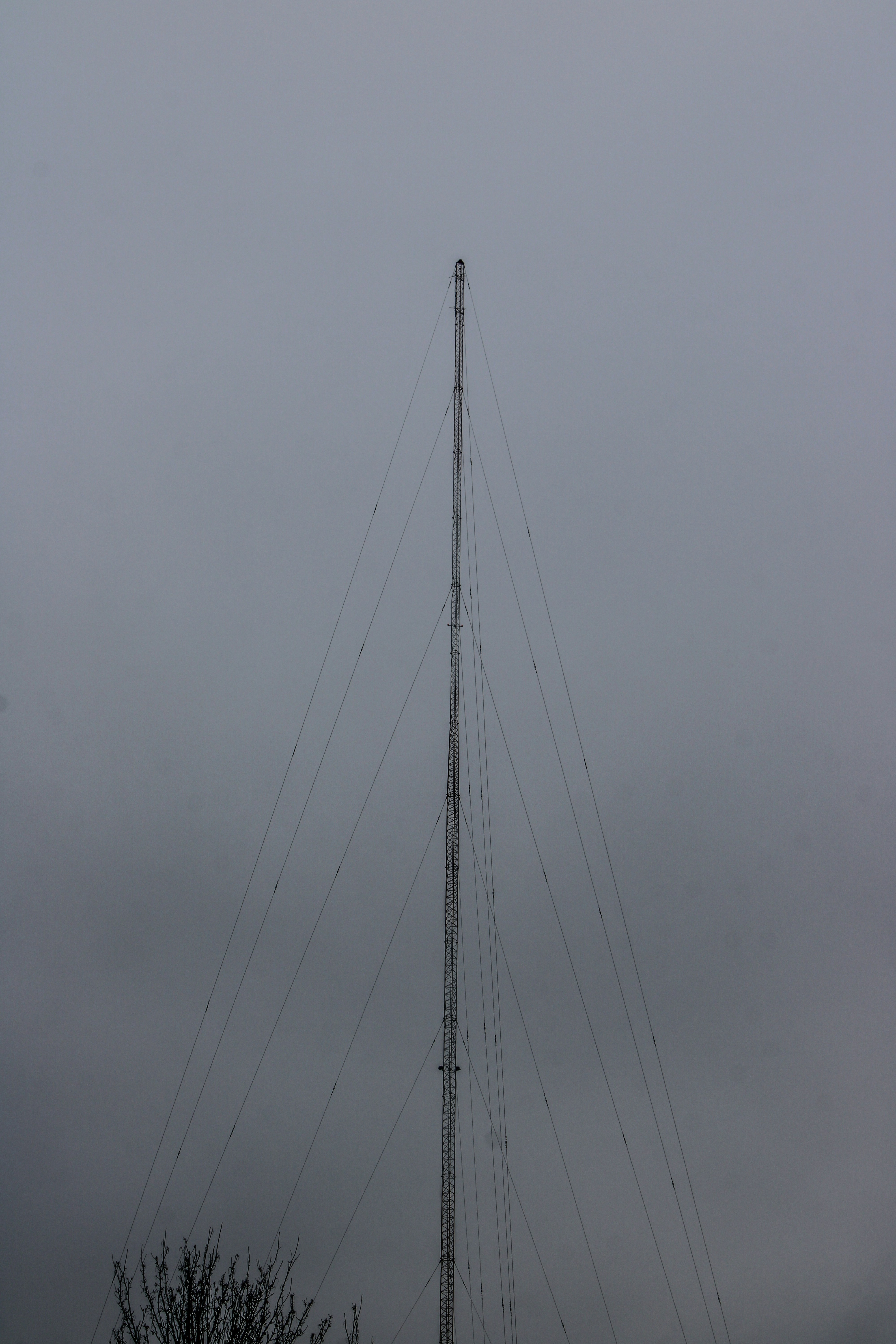 a very tall antenna on a cloudy day