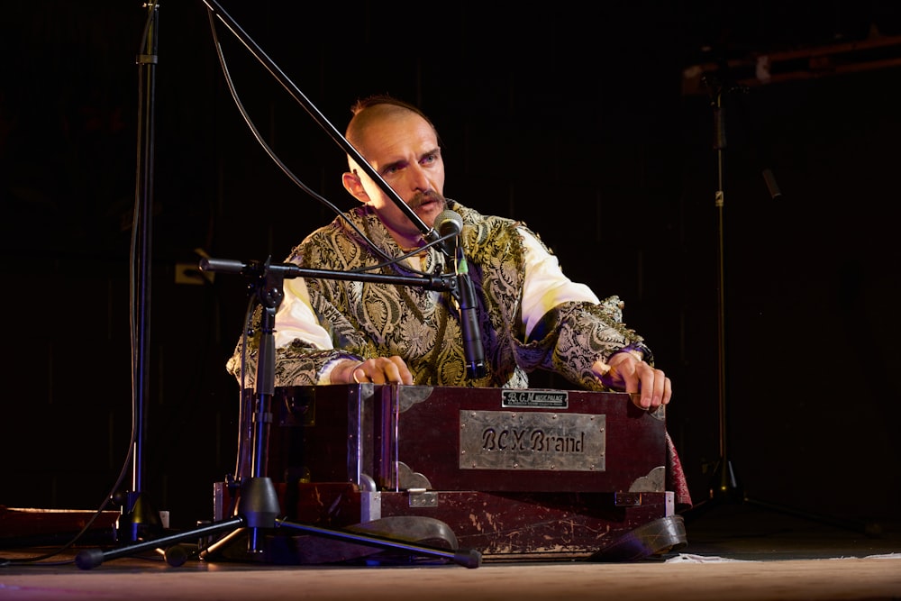 a man playing a musical instrument on a stage
