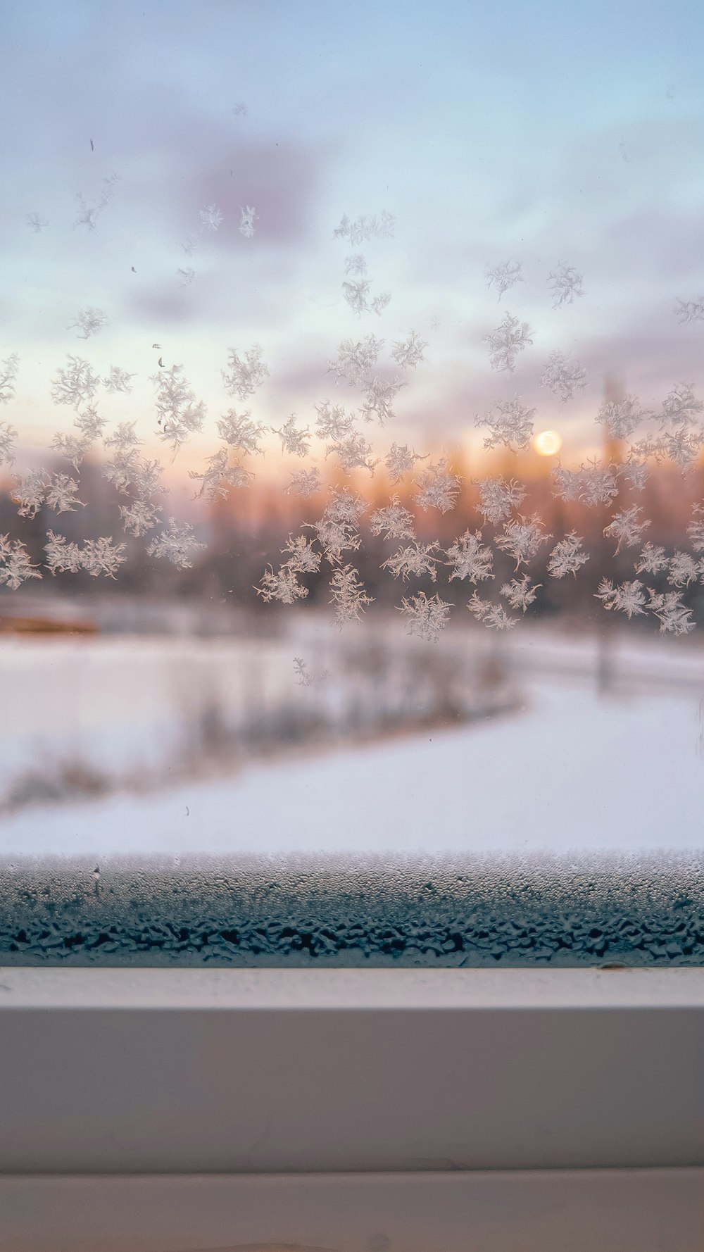 a view of a snowy landscape through a window