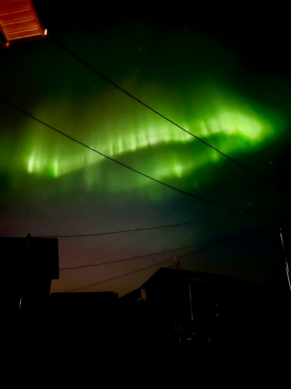 a bright green aurora bore in the night sky