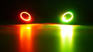 Glowing accessories like rings and pendants glowing softly in a dark setting.