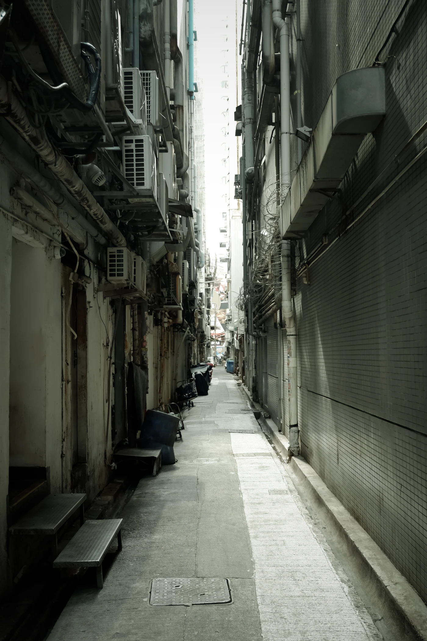 A narrow alley with a bench on the side
