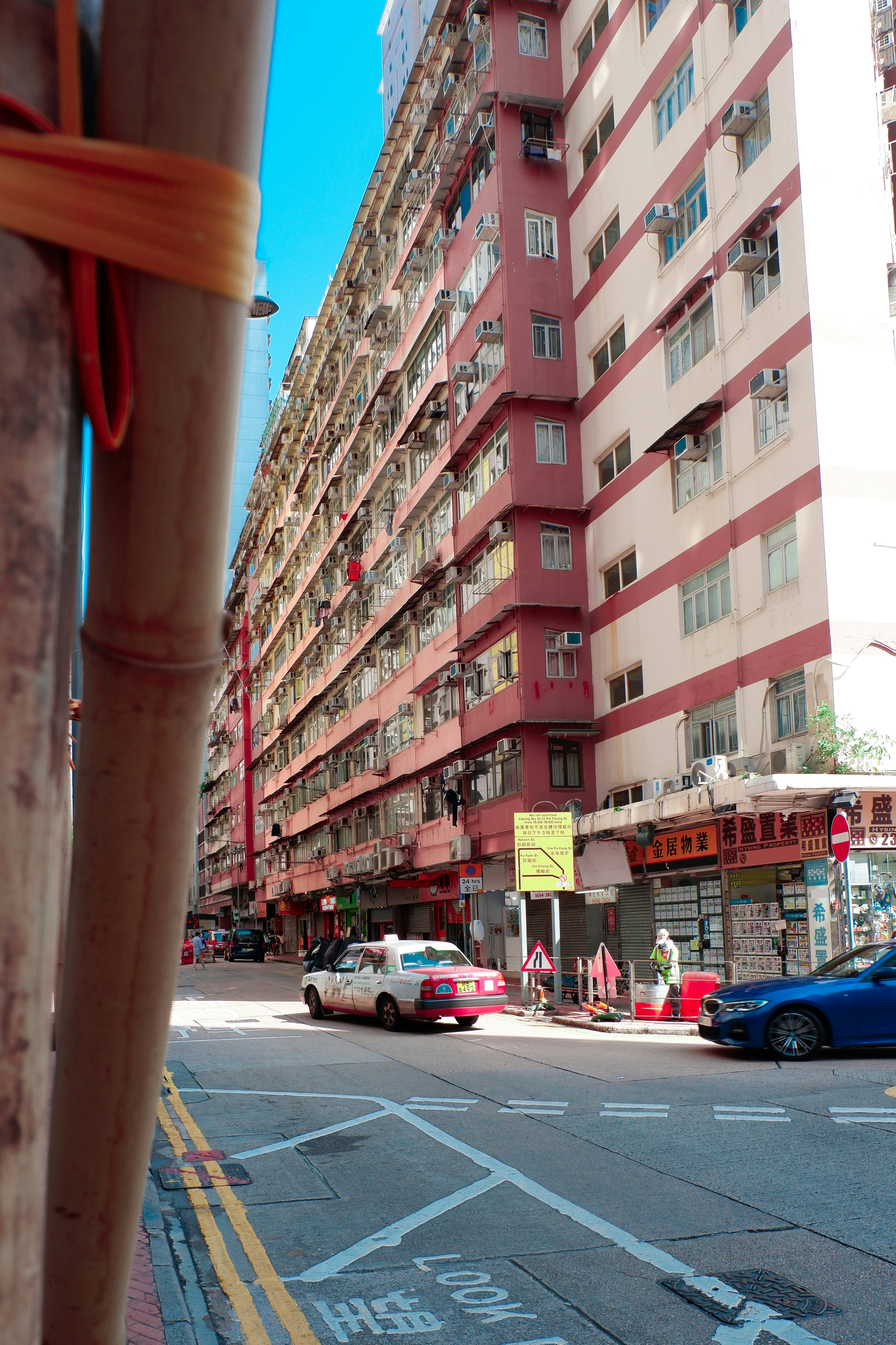 a tall red building sitting on the side of a road