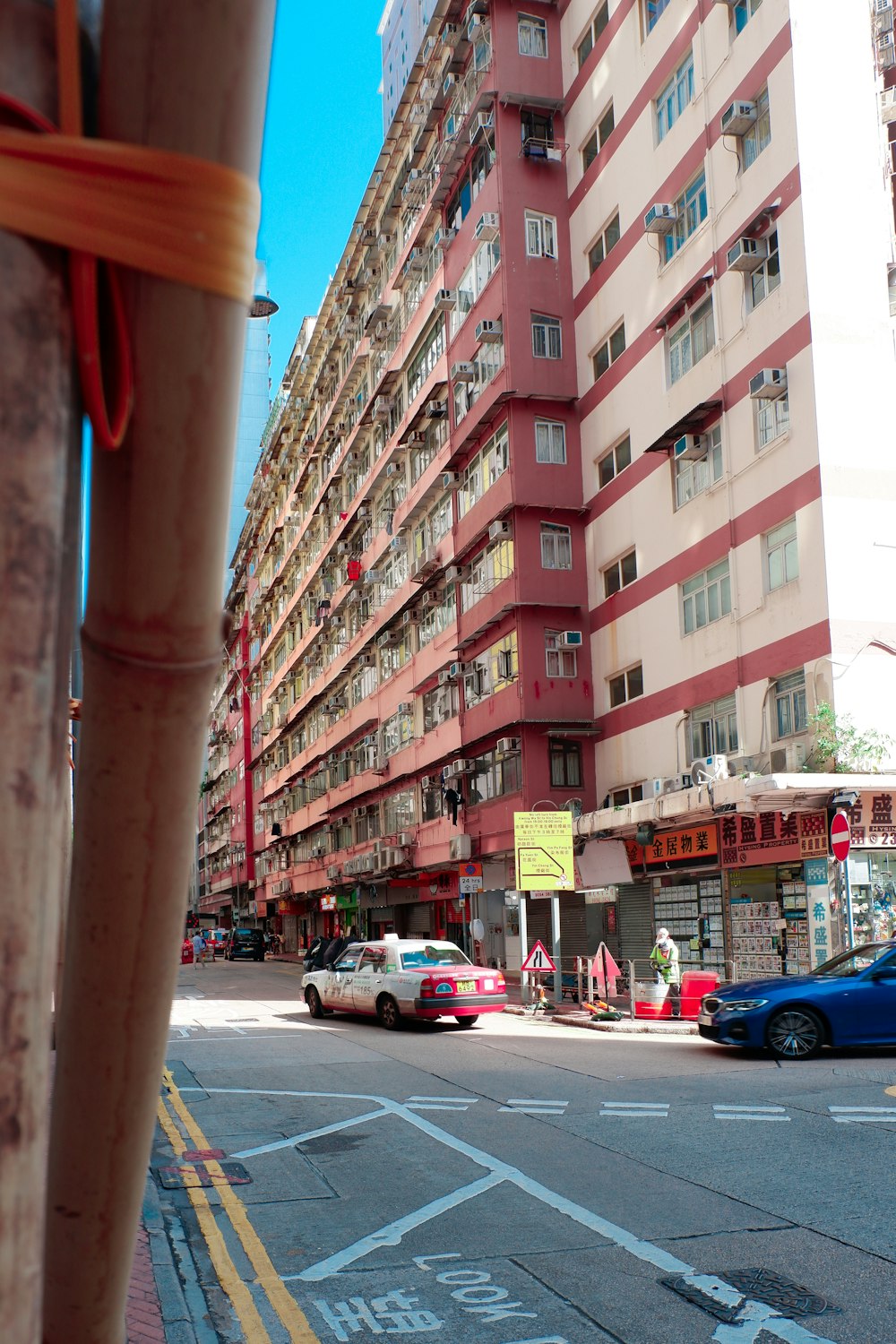 a tall red building sitting on the side of a road