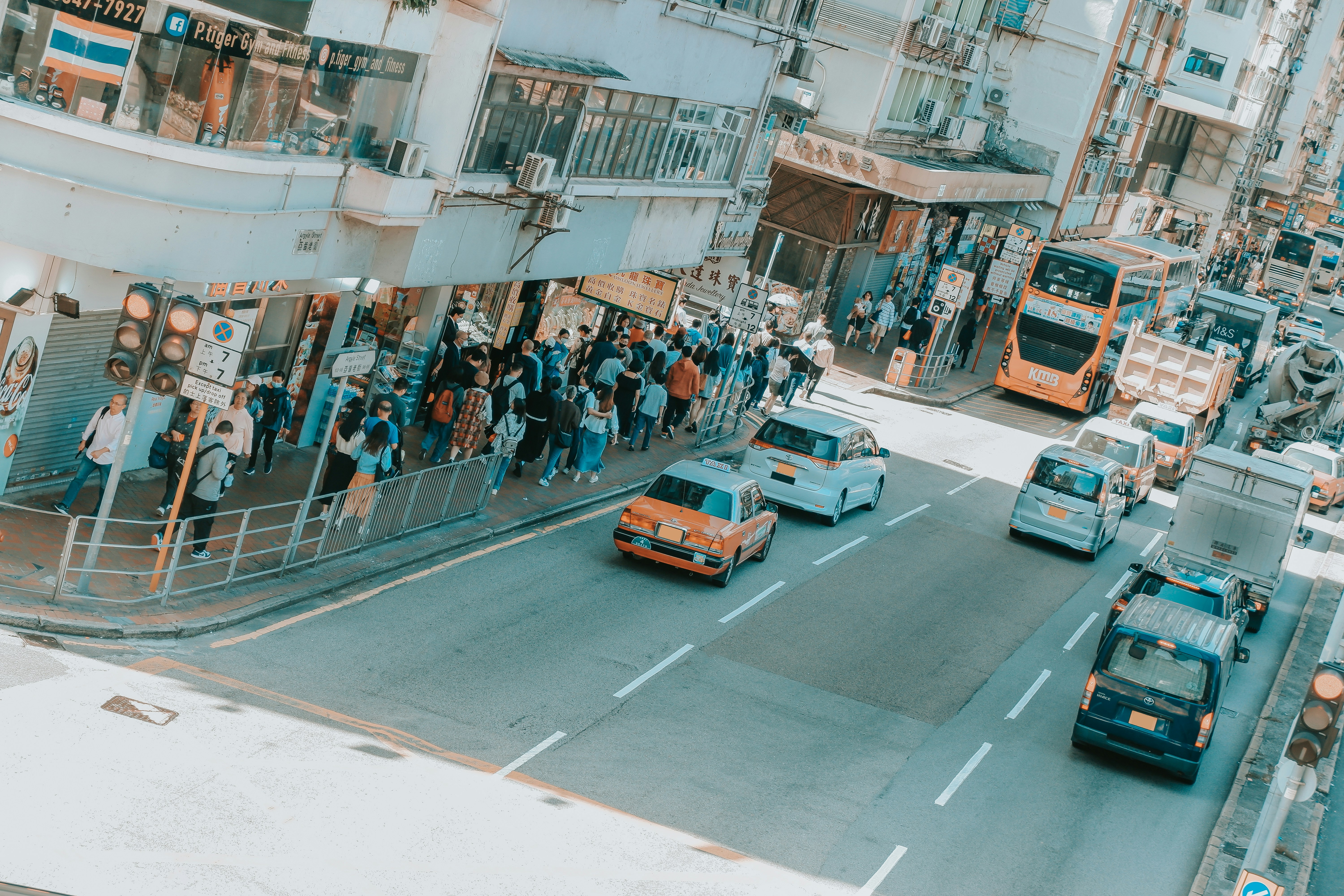 a city street filled with lots of traffic next to tall buildings