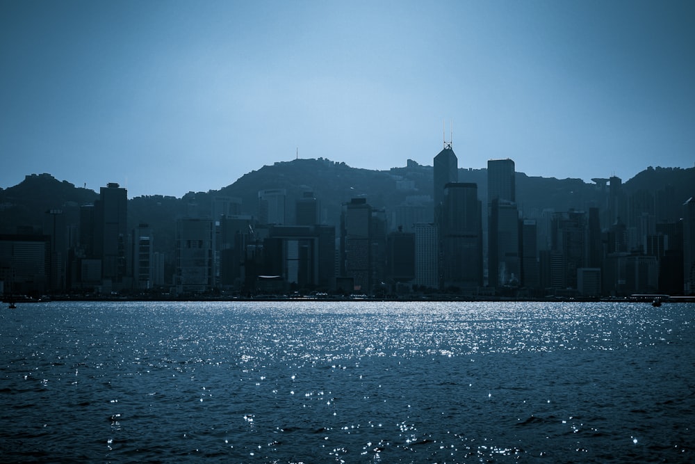 a large body of water with a city in the background