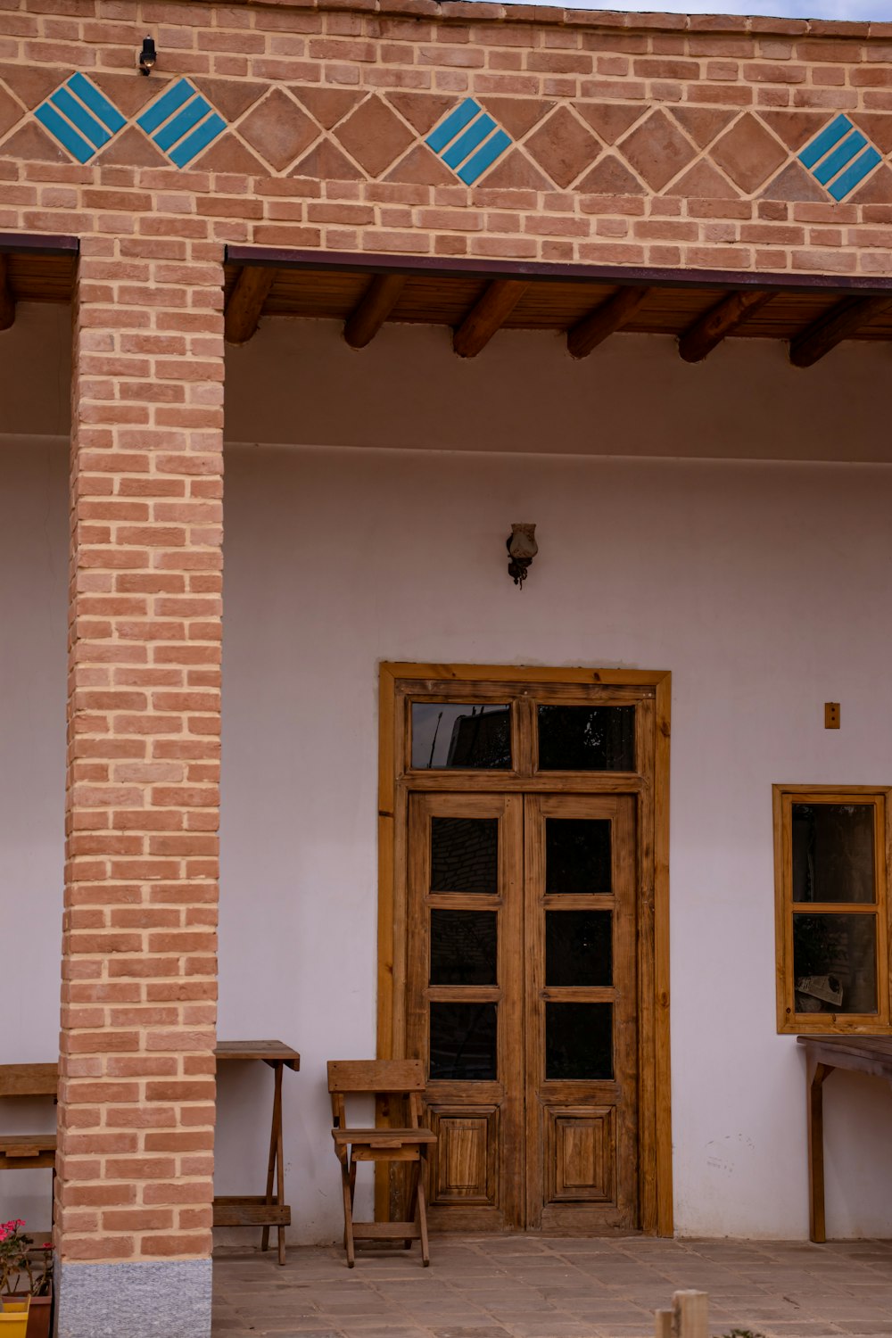 a brick building with a wooden door and windows