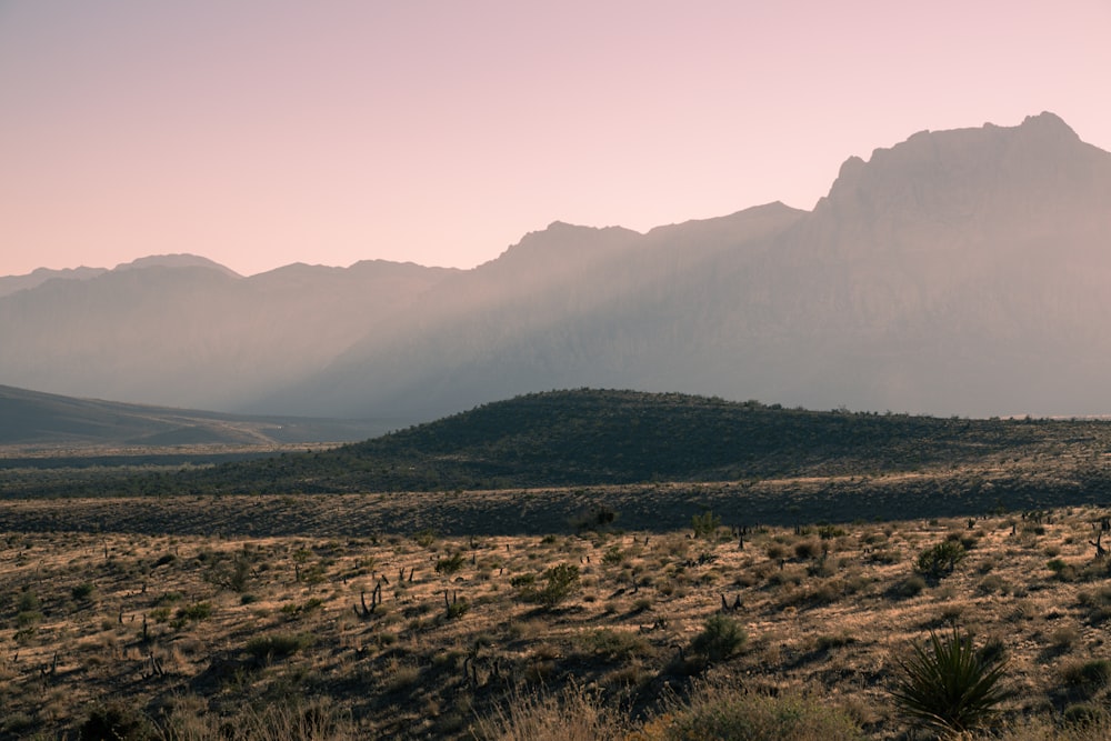 a mountain range in the distance with mountains in the background